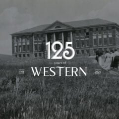 Members of the 1911 student body march up a dirt path through the weeds to Taylor Hall.