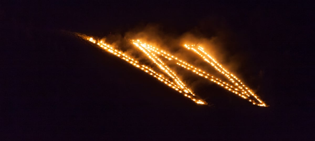 The lighting of the W on Tenderfoot Mountain during the Aspinall-Wilson Center Kickoff for Homecoming Weekend.