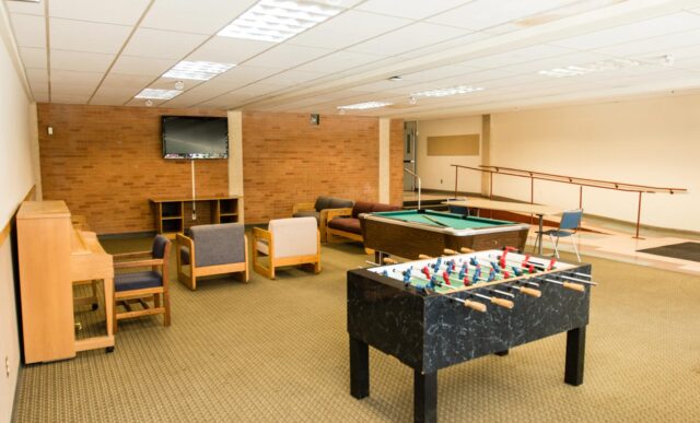 The Mears Complex community living room features a pool table and foosball table.