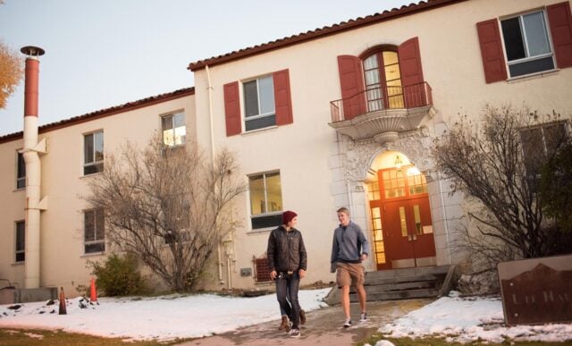 Students exit Ute Hall after sunset.
