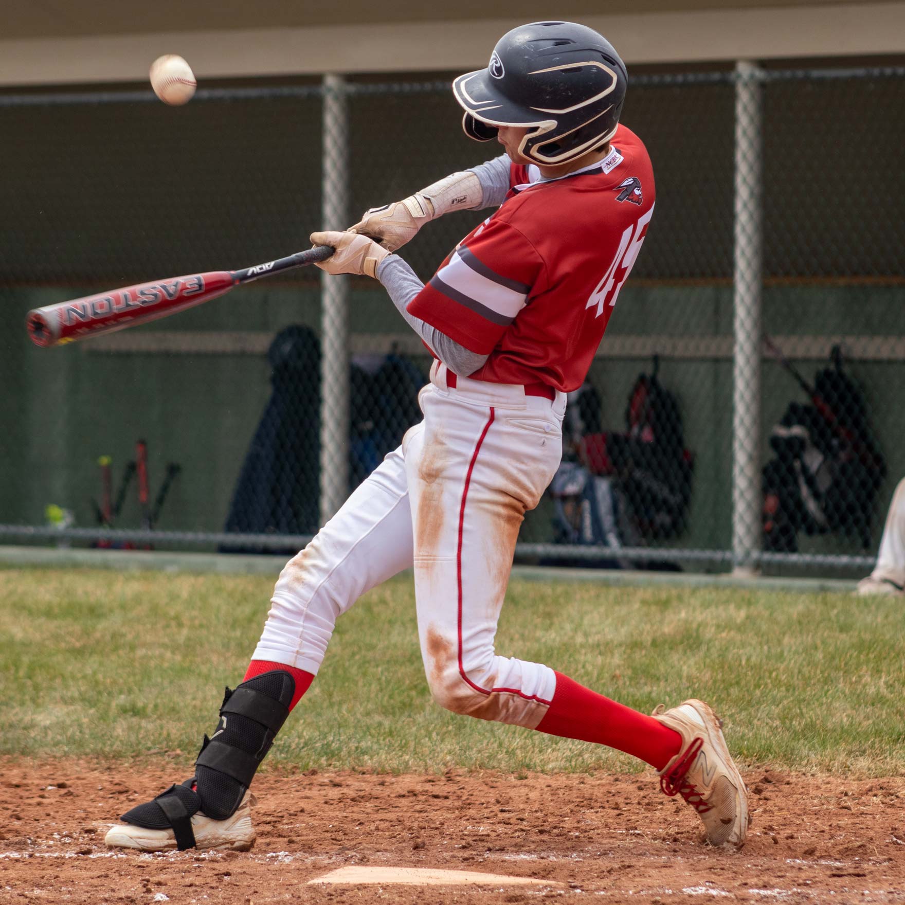 A man swings a baseball bat.