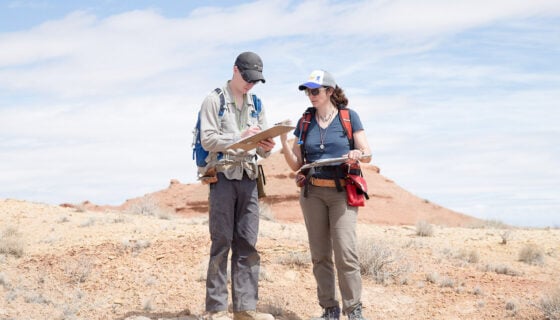 Dr. Petrie assists Kurt with his field notes.
