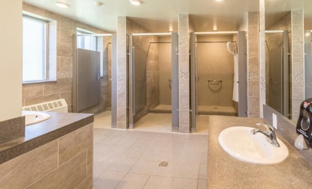 Looking into the Ute Hall restrooms with two showers and a sink visible.