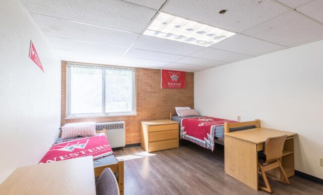 Two beds and two desks inside the Mears Complex.