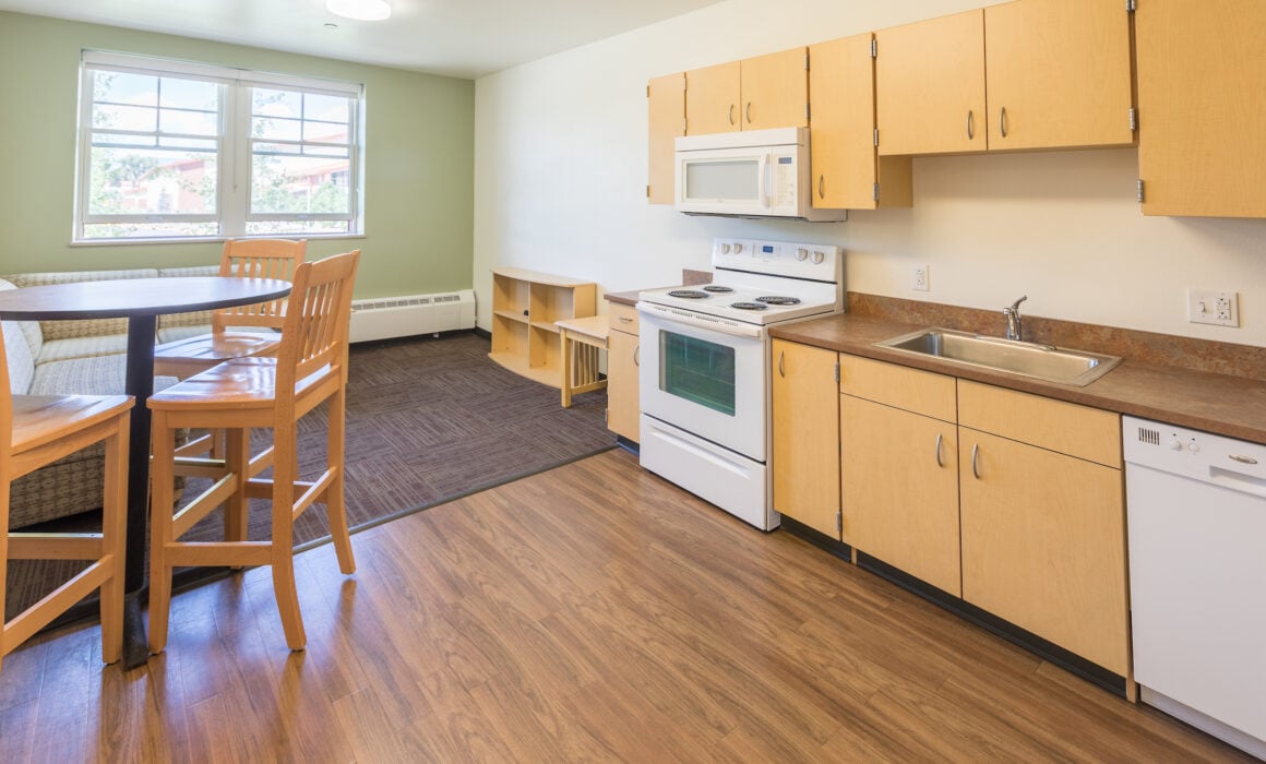 The kitchen area and living room inside the Pinnacles Apartments.