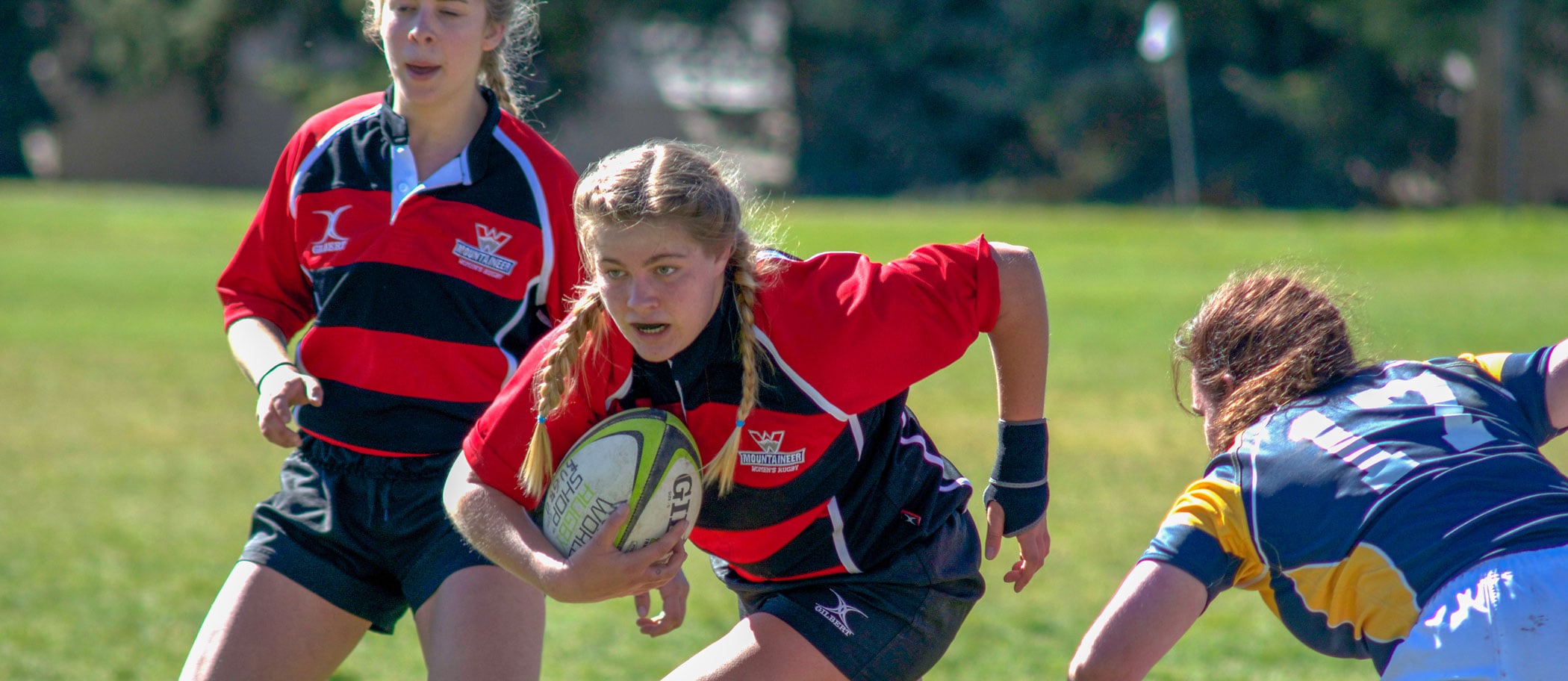 Women's rugby team playing a tough game.