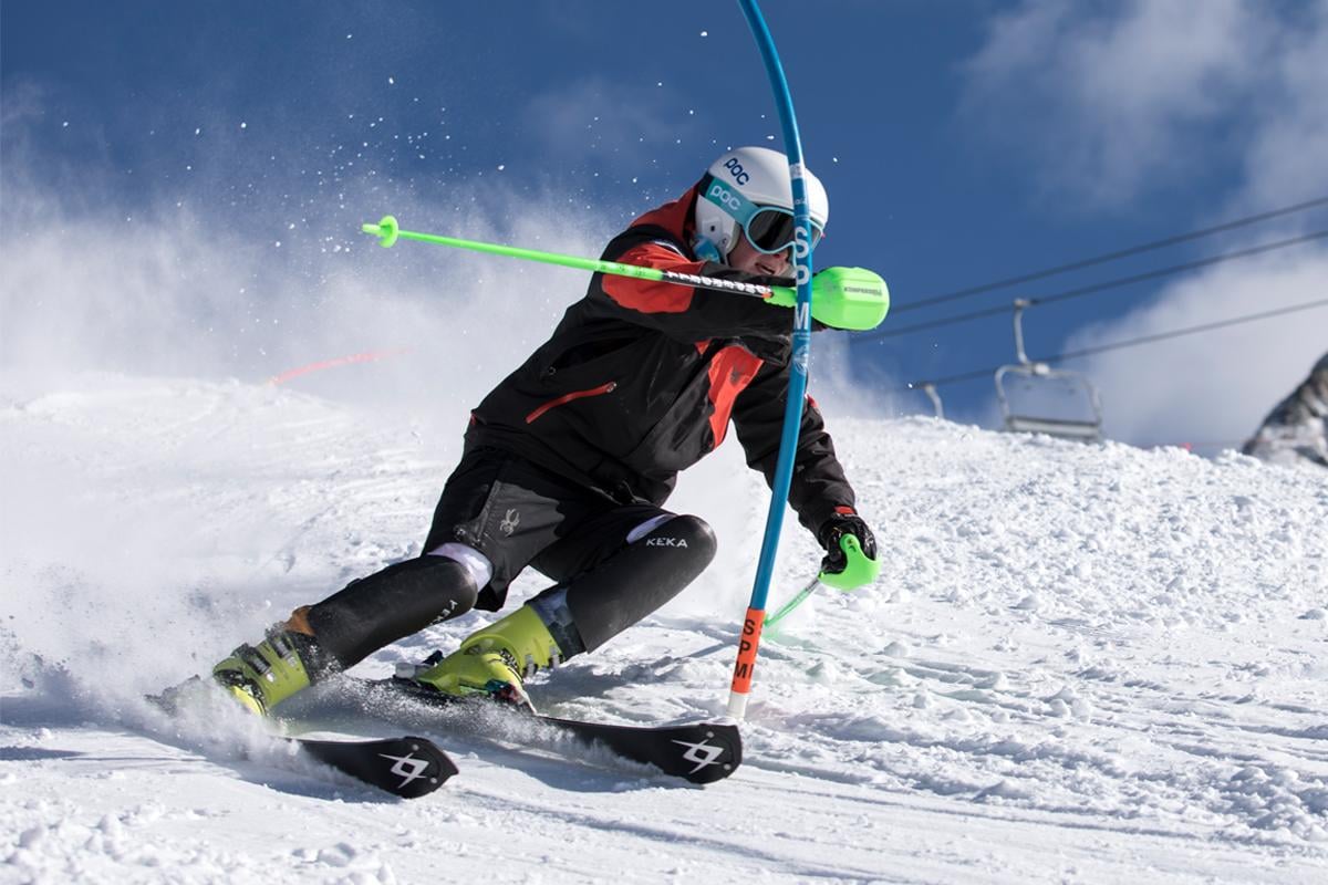 A skier races past a pole during a competition