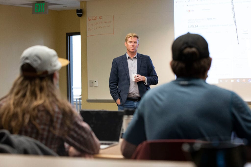 A professor delivers a lecture in a classroom