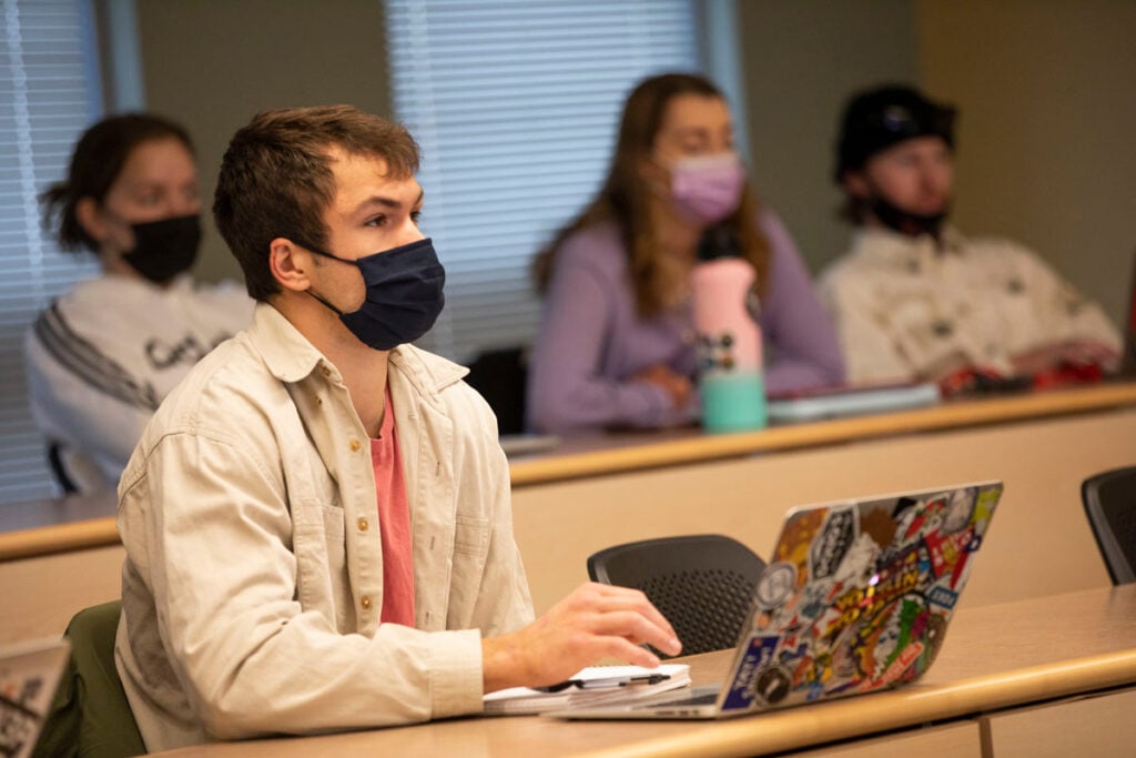 A student listens to a lecture in a classroom