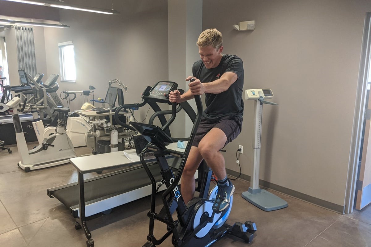 student on exercise bike