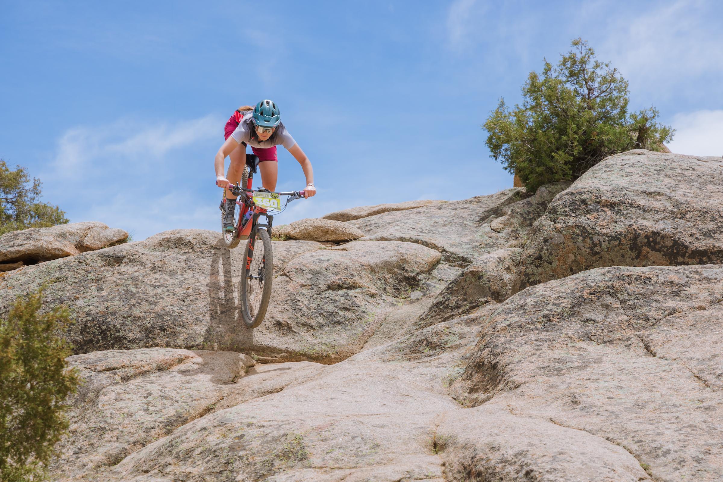 Western student, Hailey Clark, descends a rock roll while racing the Classic Growler on a sunny day.