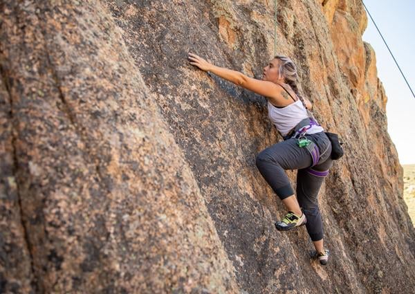 A student rock climbs