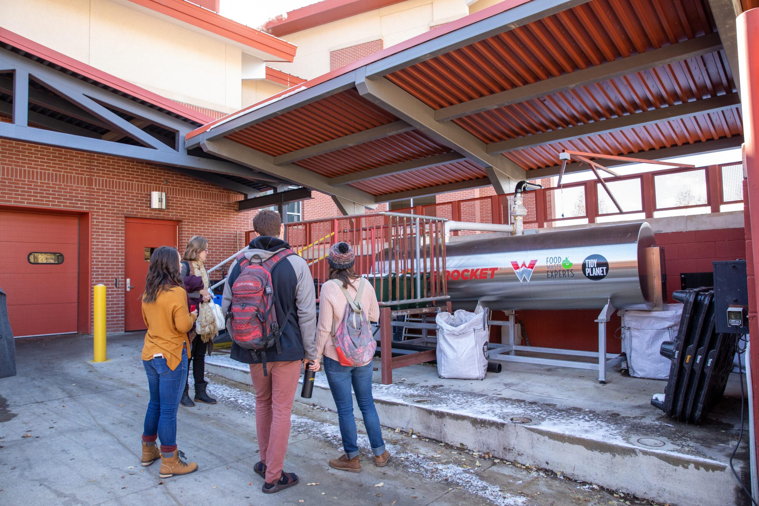 Students stand near Rocket Composter