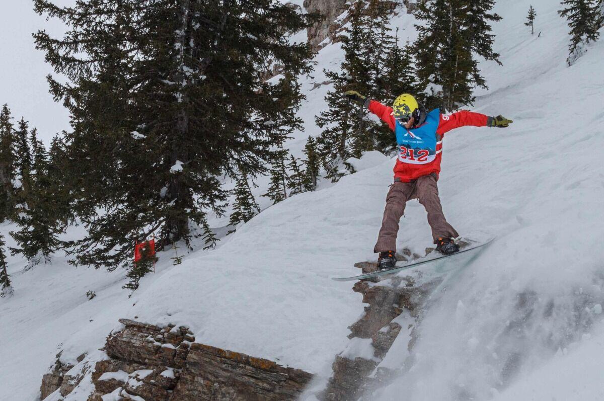 student riding snowboard