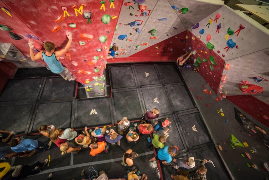 student climbing on rock wall