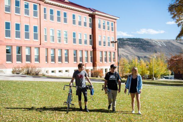 students walking outside building