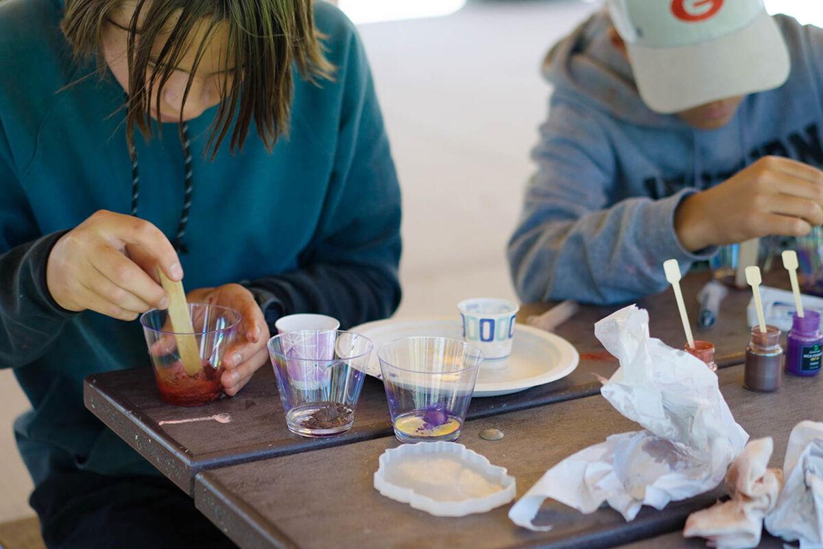 Campers doing science experiment outside