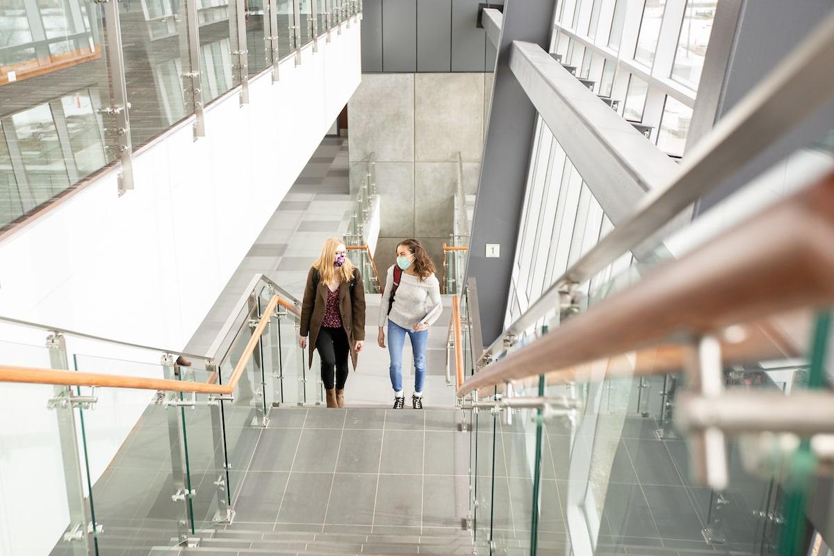 colleges with best alumni networks: two students walking up staircase