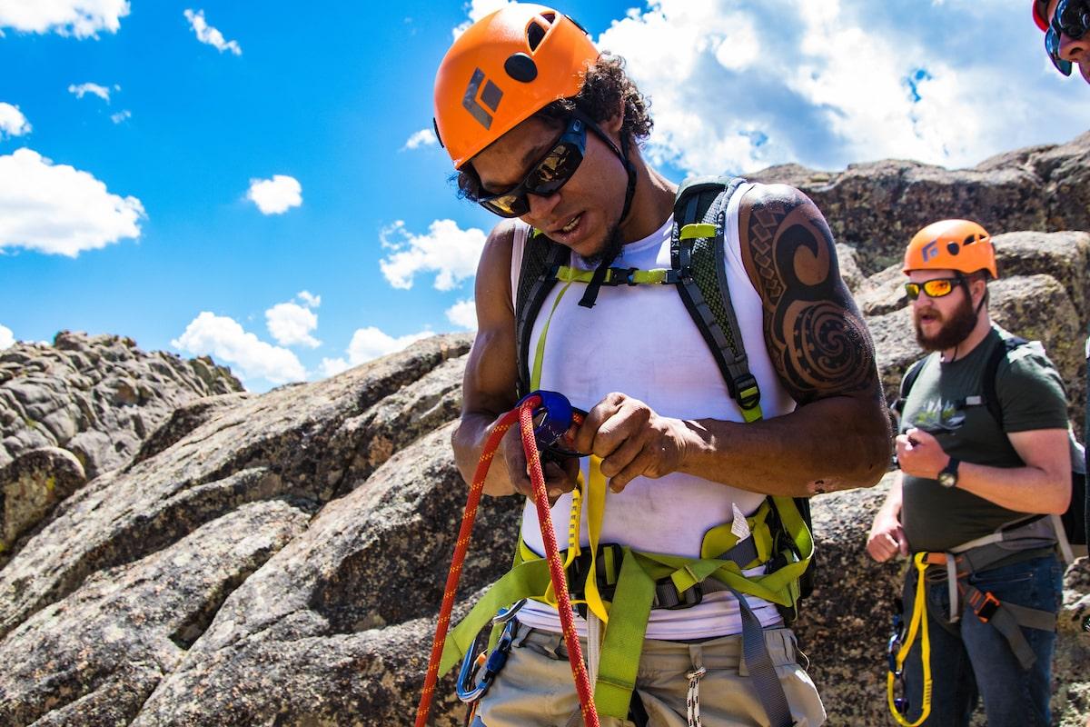 colleges near mountains: student tying climbing rope