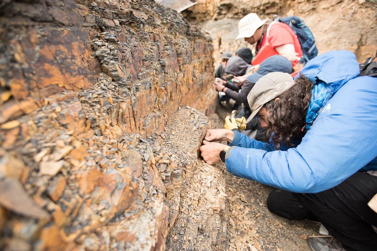 best mountain colleges: geology student studying rocks in Western Colorado