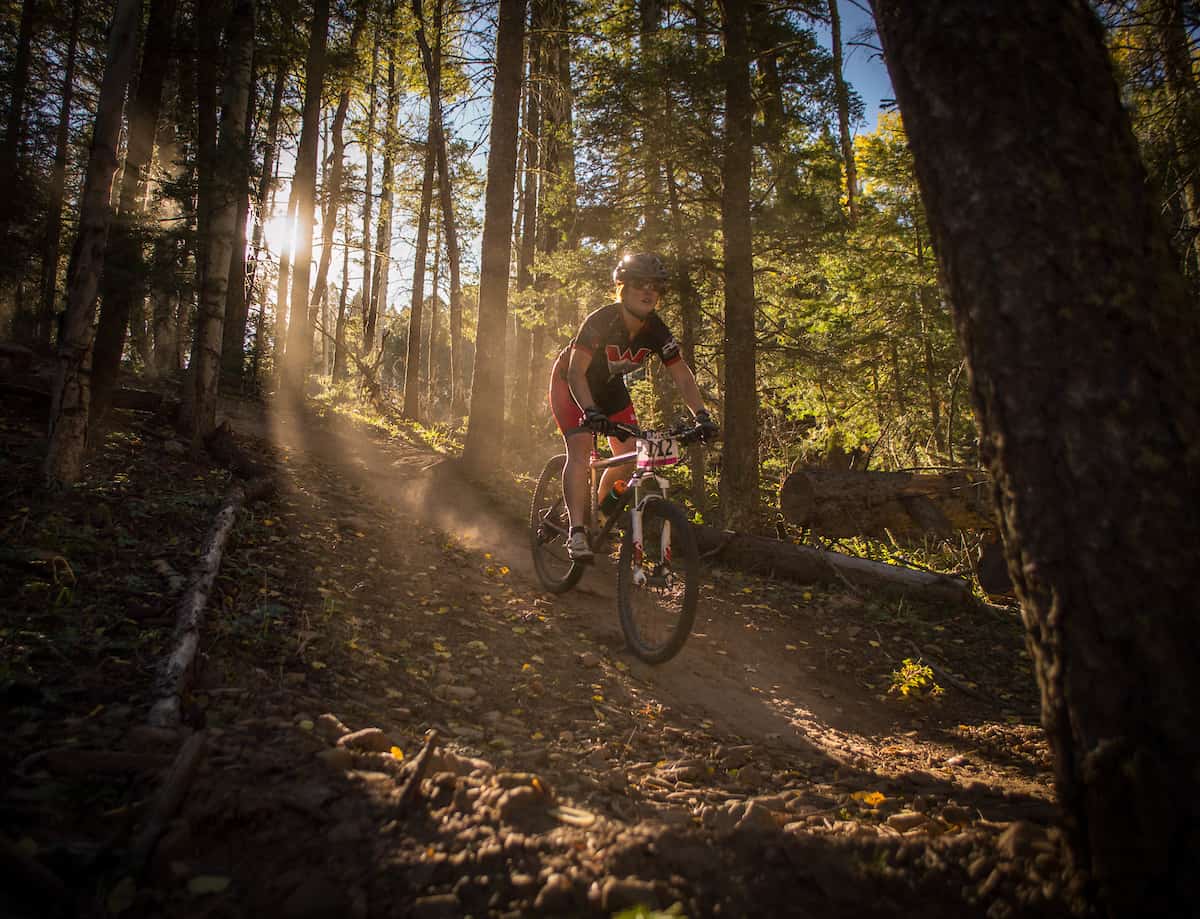 Western student rides mountain bike on trail