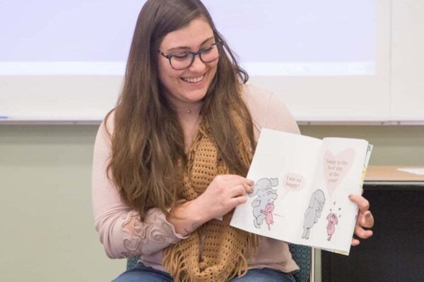 Special education graduate programs: student displays children's book