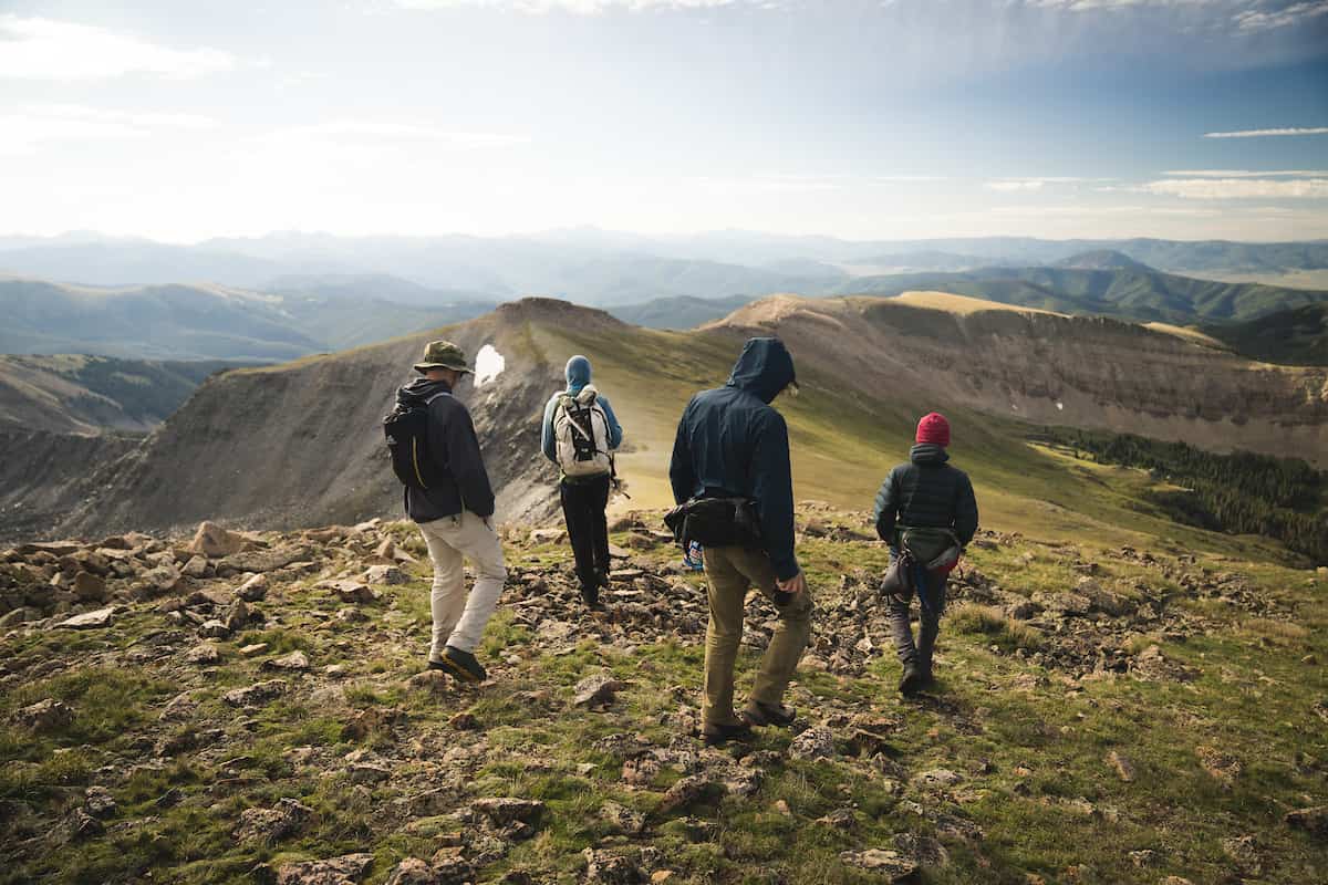 Colleges with accelerated degree programs: students hiking along top of mountain