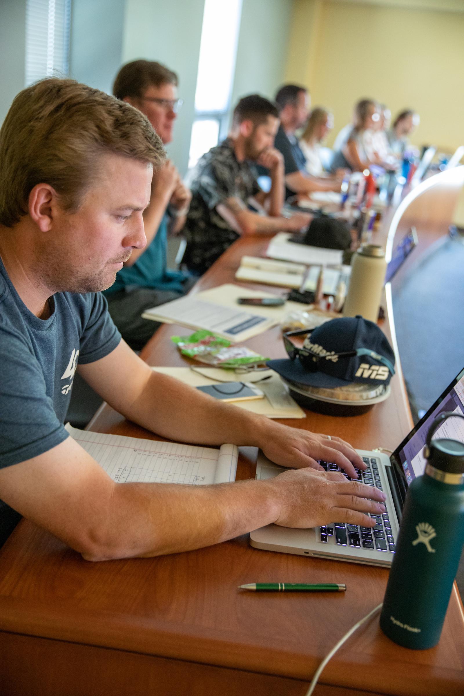 A student takes notes on a laptop.