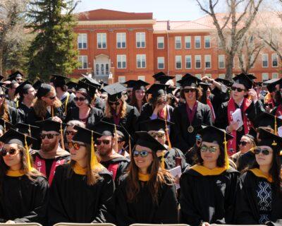 A group of graduates celebrate at their commencement ceremony