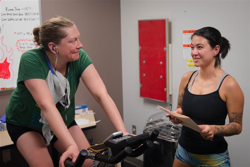 A student instructs a research participant during a study.