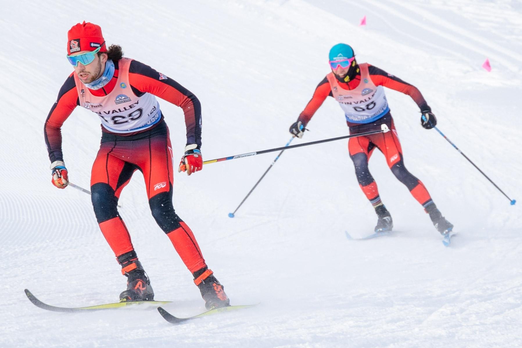 Conner Nilson and another Nordic athlete charge downhill during a race