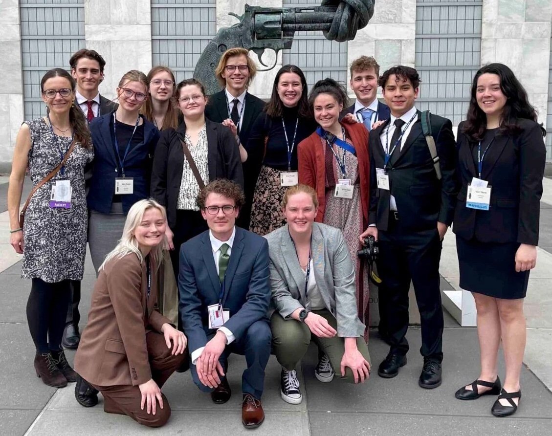 Group photo of Model UN students and professor in New York.