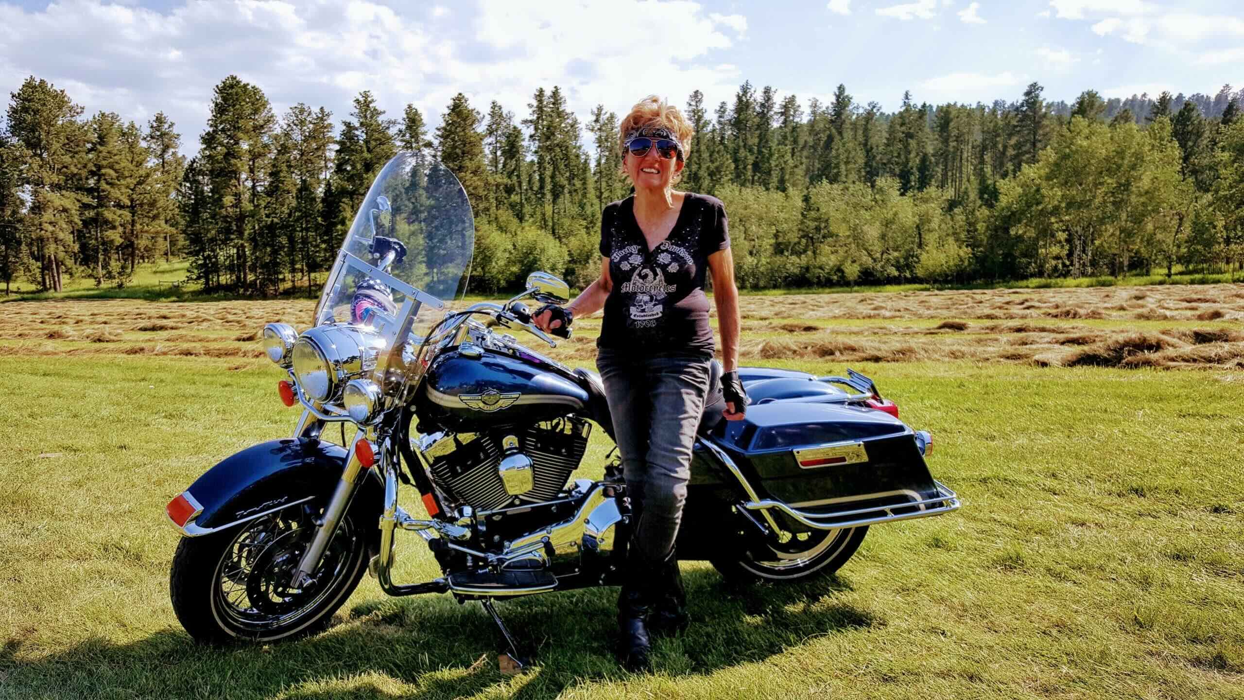 Patti poses with her motorcycle.