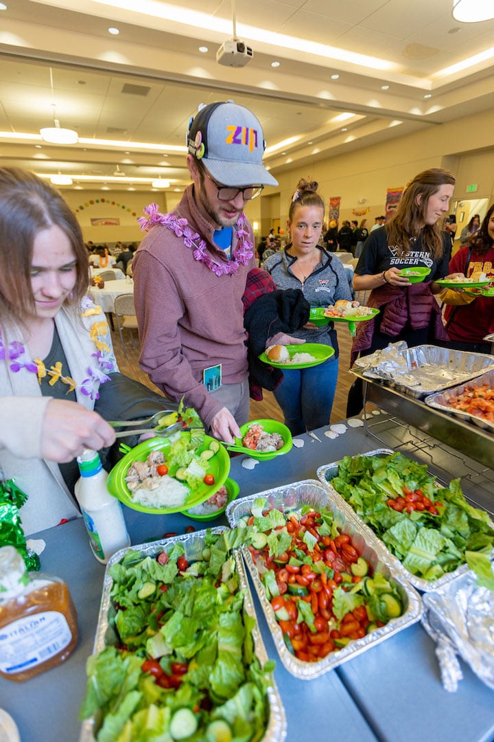 Western students prepare to get all the food that the Multi cultural Center has put together for the luau.