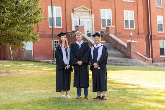 Brad Baca, Dan Gibbs and Shelby smile before the 2025 Commencement.