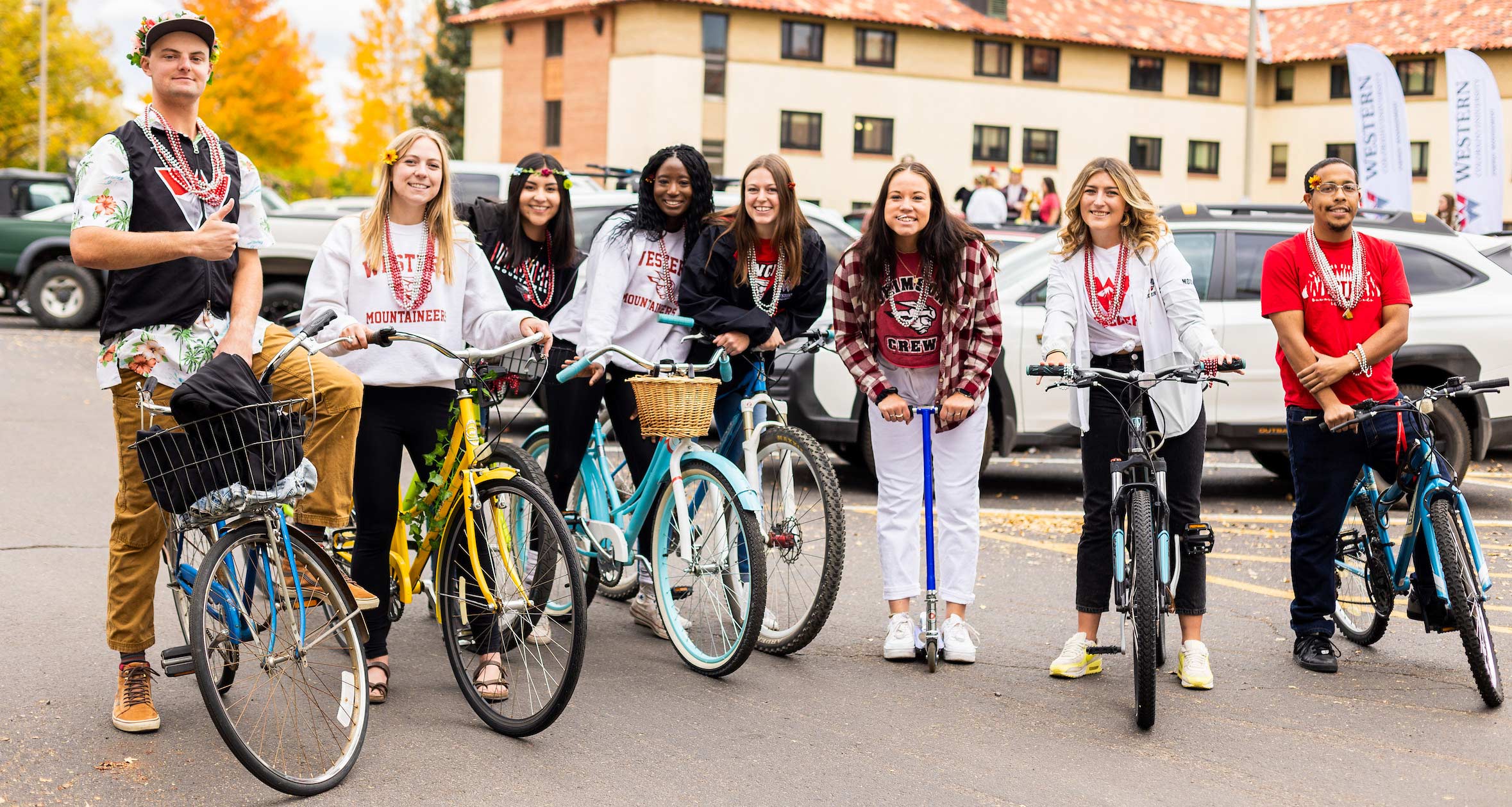Students on townie bikes gather for a group photo in front of the Chipeta Apartments in the fall.