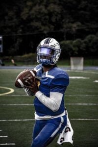 Dashown Wilson prepares to throw a football during a game
