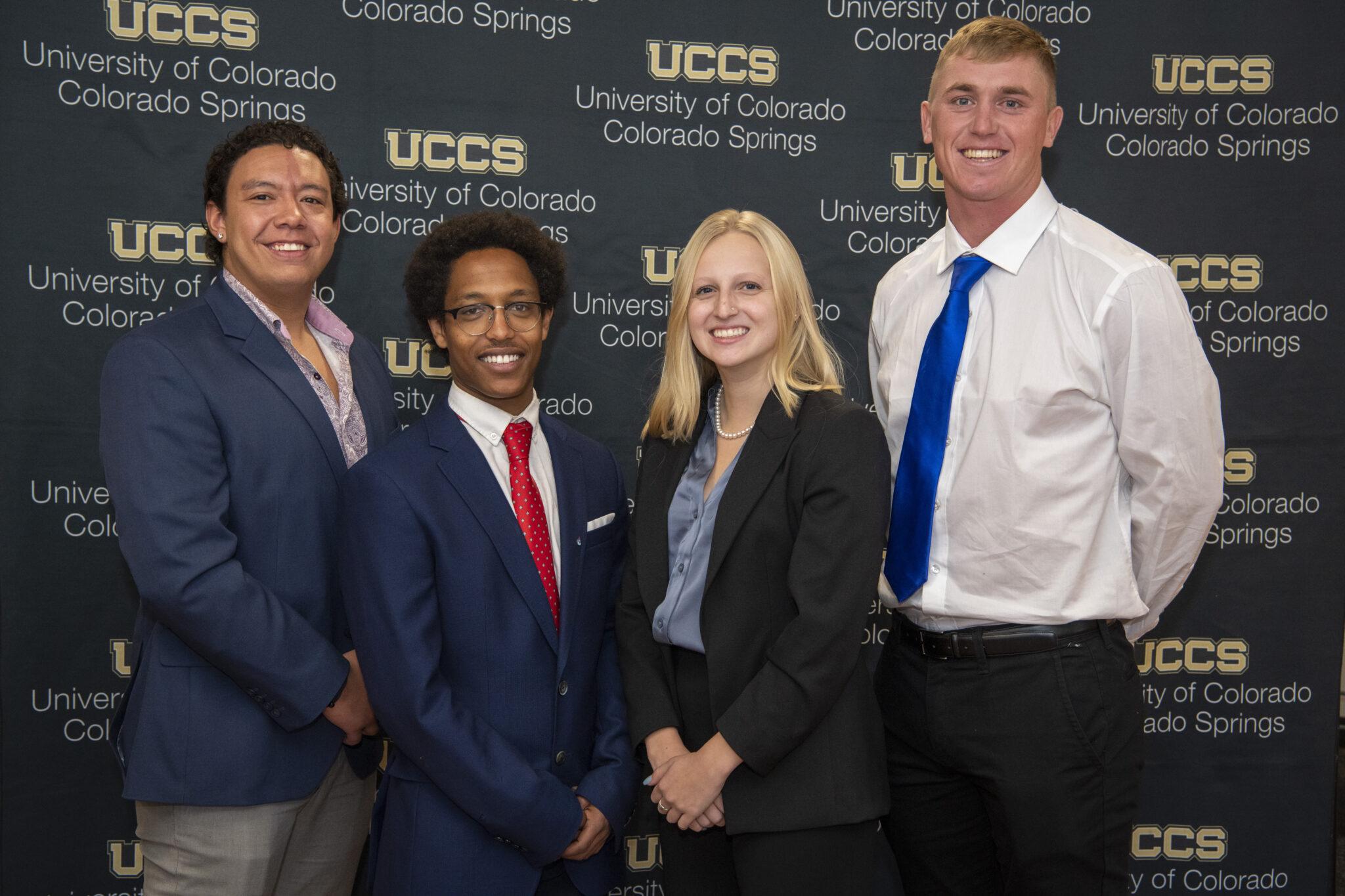 The winning team of students pose in front of a backdrop