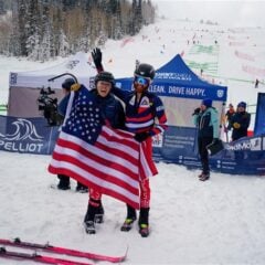 Cam Smith holds up the American flag at the Olympics.