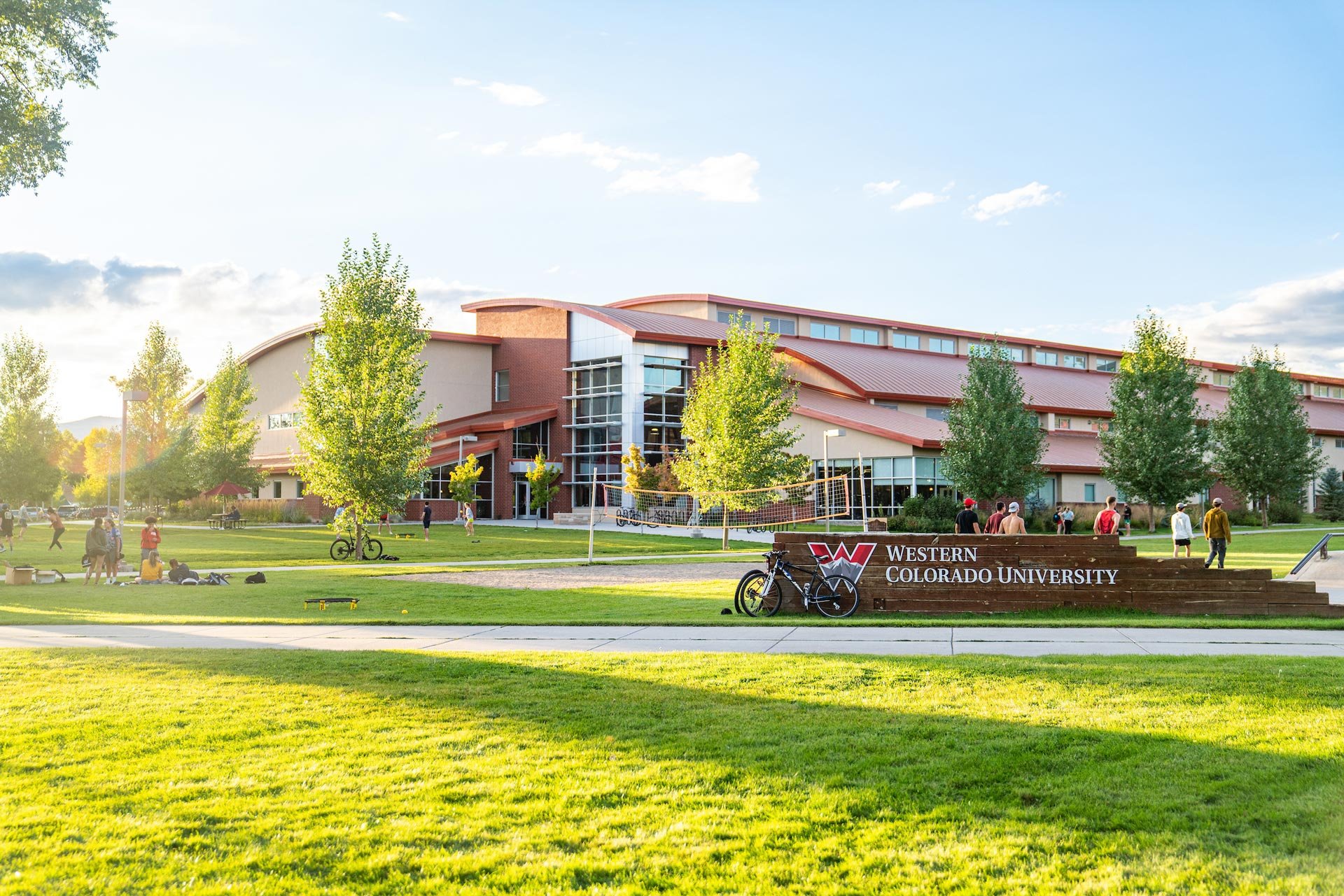 Western Colorado University Fieldhouse with several groups of students and a skate park.