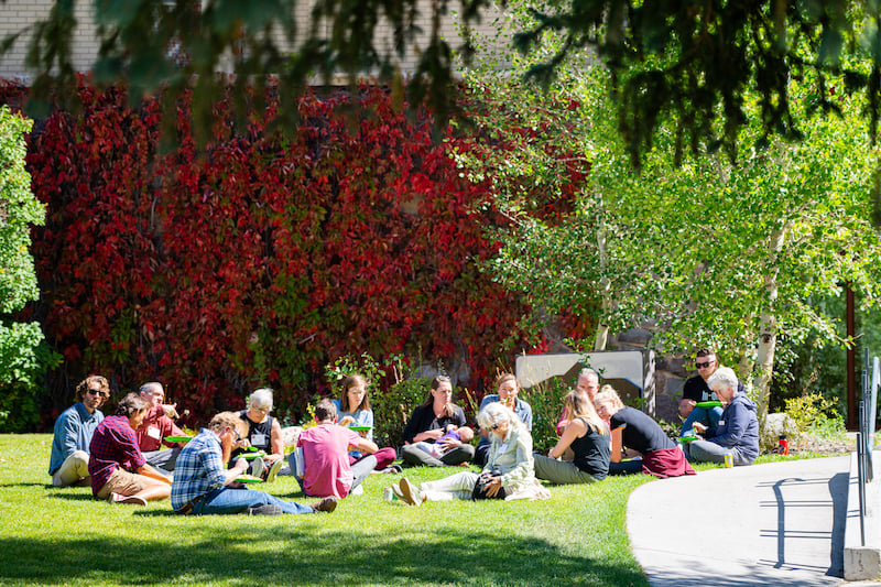 A group of students attend an outdoor class.