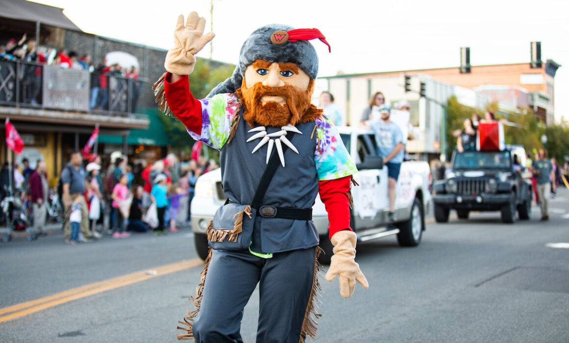 Mad Jack the Mountaineer waves to the crowd during the Western Colorado University Homecoming Parade, 2022
