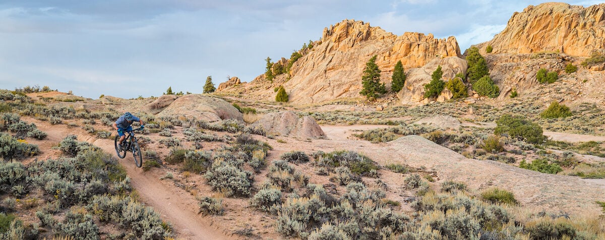 A mountain biker rides down a trail at Hartman Rocks.