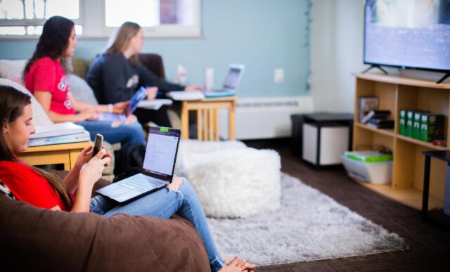 Several students hang out and do homework together.