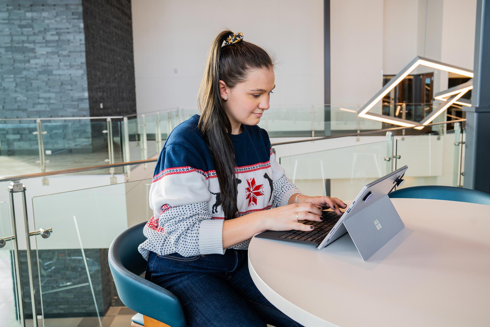A student types on a laptop while studying at the Paul M. Rady School of Computer Science & Engineering.
