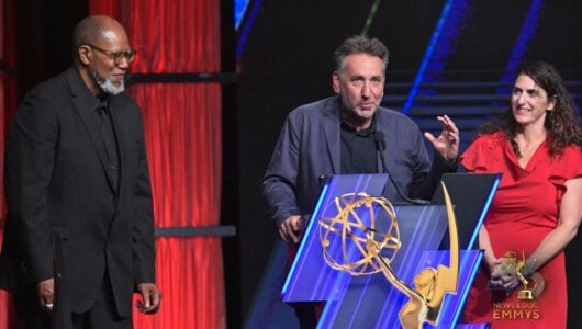 Julian Rubinstein accepts his award on stage.