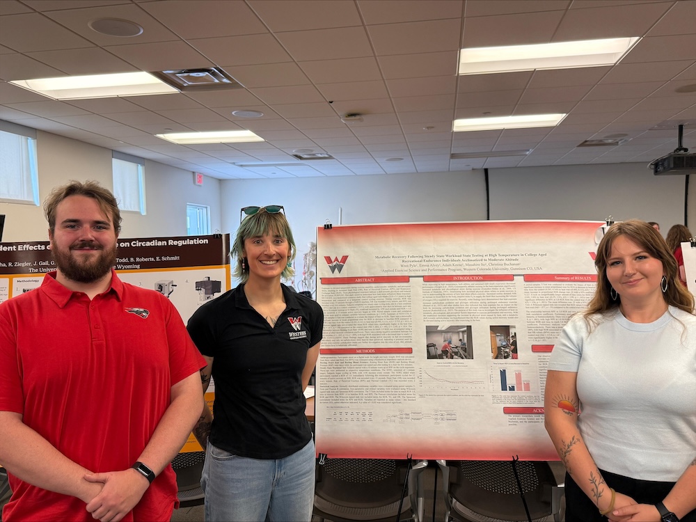 AESP students stand in front of their poster at the competition.