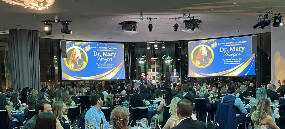 Dr. Mary Sawyer receives her award on stage.