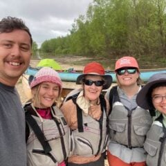 Western graduate students pose for a group shot on the Mississippi River.