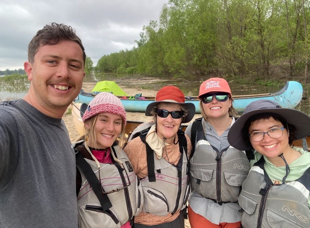 Western graduate students pose for a group shot on the Mississippi River.